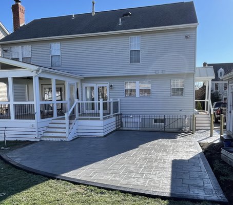 Stamped Concrete Patio with Border –Ashburn, VA - This stamped concrete patio was custom-designed to give the homeowner a durable, low-maintenance outdoor space with the look of natural stone. We used an ashlar slate pattern with a charcoal release to create depth and texture. The perimeter features a contrasting decorative border for a clean, upscale finish.
Our team handled the entire process from grading and forming to pouring, stamping, and sealing. The final result is a weather-resistant patio perfect for entertaining and built to last for decades.
We specialize in stamped concrete patios, walkways, and driveways across Northern Virginia. Every job is done with precision, honesty, and clear communication. If you're ready to upgrade your outdoor space, get in touch for a free quote today. Stamped Concrete Patio with Border –Ashburn, VA - This stamped concrete patio was custom-designed to give the homeowner a durable, low-maintenance outdoor space with the look of natural stone. We used an ashlar slate pattern with a charcoal release to create depth and texture. The perimeter features a contrasting decorative border for a clean, upscale finish.
Our team handled the entire process from grading and forming to pouring, stamping, and sealing. The final result is a weather-resistant patio perfect for entertaining and built to last for decades.
We specialize in stamped concrete patios, walkways, and driveways across Northern Virginia. Every job is done with precision, honesty, and clear communication. If you're ready to upgrade your outdoor space, get in touch for a free quote today.