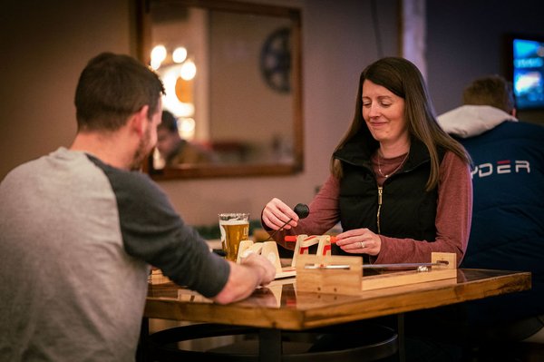 Lounge - The Axe Pit Tap Lounge is a laid-back tap room and outdoor Beer Garden designed for hanging out, not rushing out. Inside and out, you’ll find table games, board games, video games, cornhole, disc golf, and classic bean bag toss. It's perfect for groups, date nights, or casual nights with friends.
We have plants, warm night lighting, fun artwork, great music, and an easygoing crowd. The vibe is relaxed, social, and welcoming. Whether you’re throwing axes or just stopping by for a drink, this is a place to unwind, play, and stay awhile. Lounge - The Axe Pit Tap Lounge is a laid-back tap room and outdoor Beer Garden designed for hanging out, not rushing out. Inside and out, you’ll find table games, board games, video games, cornhole, disc golf, and classic bean bag toss. It's perfect for groups, date nights, or casual nights with friends.
We have plants, warm night lighting, fun artwork, great music, and an easygoing crowd. The vibe is relaxed, social, and welcoming. Whether you’re throwing axes or just stopping by for a drink, this is a place to unwind, play, and stay awhile.