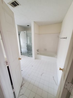 Bathroom remodel in Sandy Springs Ga - This bathroom was original and was leaking from the tub yo the garage ceiling, we water proofed it and installed new tile, glass doors and vanities Bathroom remodel in Sandy Springs Ga - This bathroom was original and was leaking from the tub yo the garage ceiling, we water proofed it and installed new tile, glass doors and vanities