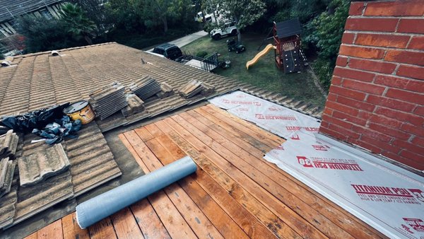 Concrete Tile Repair - This Roof needed some repairs and new underlayment installed around the chimney base to prevent water entry.
