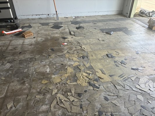 Tile removal to cleanable floor in just one day. - Customer was having trouble getting his tile off. Got about a quarter of it off gave us a call. We removed it Grind it down and laid a thick coat of epoxy with flake and added a poly aspartic clearcoat to protect it from yellowing. Now he has a nonslip surface.