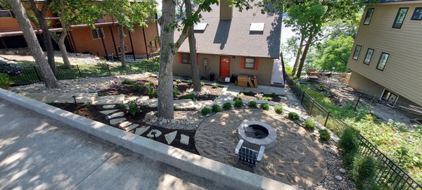 Shumate: Lakeside Outdoor Living Retreat - This client wanted to turn the steep hill leading down to their lakeside home into useable outdoor living area. We built retaining walls to create tiered planting beds, and a large flat area for a firepit. Shumate: Lakeside Outdoor Living Retreat - This client wanted to turn the steep hill leading down to their lakeside home into useable outdoor living area. We built retaining walls to create tiered planting beds, and a large flat area for a firepit.