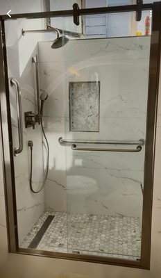 Hallway Bathroom Walk in Shower in Daly City - This hallway bathroom was upgraded to improve accessibility, safety, and style. The existing bathtub was removed and replaced with a walk-in shower featuring a sleek glass door. A built-in bench, recessed shampoo niche, and secure grab bar were added for comfort and convenience. The walls and floor were retiled with durable, modern finishes. The customer was absolutely thrilled with the results. They were happy and satisfied with the beautiful transformation. Hallway Bathroom Walk in Shower in Daly City - This hallway bathroom was upgraded to improve accessibility, safety, and style. The existing bathtub was removed and replaced with a walk-in shower featuring a sleek glass door. A built-in bench, recessed shampoo niche, and secure grab bar were added for comfort and convenience. The walls and floor were retiled with durable, modern finishes. The customer was absolutely thrilled with the results. They were happy and satisfied with the beautiful transformation.