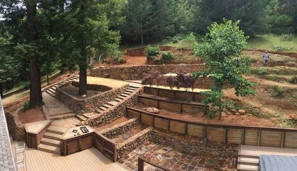 Terraced backyard - This project was completely designed and built by Award Winning Masonry. It included natural stone retaining walls, stairs, patios, garden beds, and walk ways with decomposed granite landings. Unfortunately this job was located on Markwest Springs Road in Santa Rosa. We completed it just months before the wildfire claimed the home. All that was left standing was the stone work.