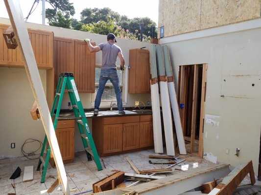 Demolition - Customer requested demolition and hauling of the kitchen and living room. Kitchen: removal of countertops upper and lower cabinets, stove, tile floor, windows, celling, and sink. Living room: removal of sofas, wood floors, celling, walls, windows and chimney.