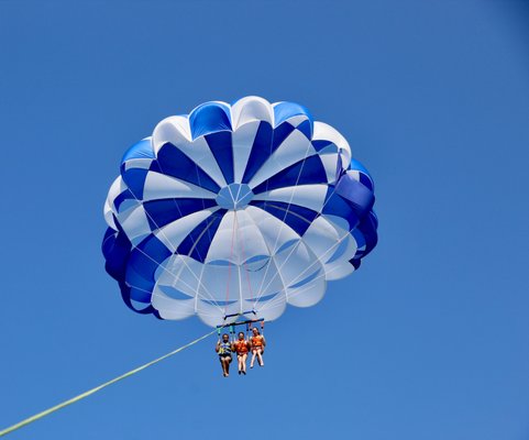 Parasailing - Soar high above the sparkling waters with our exhilarating parasailing adventures! At Dennis Parasail and Jet Ski, we specialize in providing unforgettable parasail experiences for thrill-seekers and nature lovers alike. Located in the heart of Cape Cod (Dennis), our professional and experienced team is committed to ensuring your safety while delivering the ultimate adrenaline rush.
Imagine the breathtaking views as you're lifted into the sky, gently floating among the clouds, and marveling at the stunning coastline below. Our state-of-the-art equipment and well-trained staff guarantee a smooth and secure parasailing adventure. Whether you're a first-time flyer or a seasoned enthusiast, we offer a range of options to suit your preferences, from solo flights to tandem experiences for sharing the thrill with a friend.
With a strong focus on customer satisfaction, we go above and beyond to create an exceptional experience for each guest. Our friendly staff is always ready to assist you, from providing comprehensive safety instructions to ensuring you're comfortable throughout the entire adventure. We prioritize your enjoyment and strive to make every moment unforgettable. Parasailing - Soar high above the sparkling waters with our exhilarating parasailing adventures! At Dennis Parasail and Jet Ski, we specialize in providing unforgettable parasail experiences for thrill-seekers and nature lovers alike. Located in the heart of Cape Cod (Dennis), our professional and experienced team is committed to ensuring your safety while delivering the ultimate adrenaline rush.
Imagine the breathtaking views as you're lifted into the sky, gently floating among the clouds, and marveling at the stunning coastline below. Our state-of-the-art equipment and well-trained staff guarantee a smooth and secure parasailing adventure. Whether you're a first-time flyer or a seasoned enthusiast, we offer a range of options to suit your preferences, from solo flights to tandem experiences for sharing the thrill with a friend.
With a strong focus on customer satisfaction, we go above and beyond to create an exceptional experience for each guest. Our friendly staff is always ready to assist you, from providing comprehensive safety instructions to ensuring you're comfortable throughout the entire adventure. We prioritize your enjoyment and strive to make every moment unforgettable.