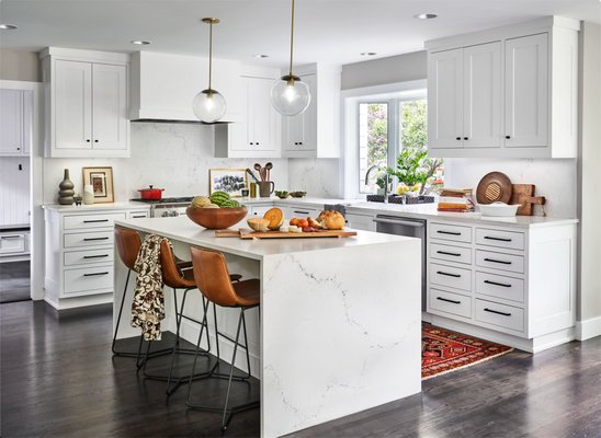 2020 kitchen and whole home renovation - This modern kitchen remodel features a stunning contrast between crisp white cabinetry and rich, dark wood floors, creating a sophisticated and timeless look. The sleek white cabinets bring a clean, fresh aesthetic to the space, while the dark wood flooring adds warmth and depth, balancing the overall design. Quartz countertops in a soft, neutral tone provide a seamless, elegant surface that is both durable and low-maintenance, perfect for busy households. Subtle yet polished hardware and strategic lighting complete the transformation, making this kitchen a bright, inviting space with a harmonious blend of modern style and classic elegance.