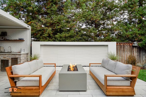 The Cascades Project | Backyard Remodel - Welcome to 'The Cascades Project' in Morgan Hill. An exceptional example of how even a smaller backyard can be transformed into a true entertainer’s retreat. Every element was fully customized, from the motorized louvered pergola to the striking weeping wall and the complete outdoor kitchen. The hardscape was thoughtfully designed to seamlessly extend the finishes and aesthetic of our clients’ home, creating a cohesive indoor-outdoor living experience.