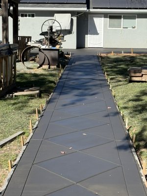 Diamond design back yard. In Arroyo Grande CA 93420 - Installation of a custom concrete backyard hardscape featuring a decorative diamond pattern layout. Scope includes surface preparation, layout, forming, placement, finishing, and control joints to achieve a clean, symmetrical diamond design with long-lasting durability and proper drainage.