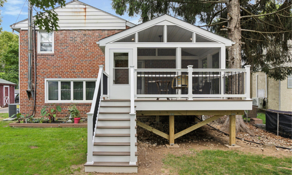 Screened-in Porch Room on Composite Deck - When an aging-in-place couple approached us with a vision for a comfortable and accessible outdoor space, we knew their dream of a screened porch deck would require thoughtful deck design and expert craftsmanship. They’d been in their home for many years and were ready for a deck renovation to really begin enjoying the outdoors. A pesky tree, dropping lots of needles and pinecones, had just been removed so the time was right for begin looking into composite decking options. Our goal was to create safe, stylish, and functional deck ideas that would allow them to enjoy their backyard in all seasons.
The key was to create a low-maintenance composite deck with a roof covering enough area to have a large dining table. Their desire was to have the covered porch completely screened-in, even on the floor beneath the deck boards, to keep all bugs and mosquitoes out. Vitamin D was a priority, so another main aspect to the deck construction was to leave space outside of the a-frame roof for a sundeck to enjoy a warm spring afternoon. We achieved the low-maintenance upkeep of the deck by installing composite decking, a vinyl soffit ceiling and vinyl-wrapped posts. The only element needing upkeep every few years will be the screens as the material experiences more sunlight and harsh weather exposure.
Dexteriors specialize in custom deck and patio construction, and we were ready to get started building this screened porch deck. The planning went smooth and the homeowners were ready to get building right away. After breaking ground, construction lasted about 9 days with a few delays due to weather. Screened-in Porch Room on Composite Deck - When an aging-in-place couple approached us with a vision for a comfortable and accessible outdoor space, we knew their dream of a screened porch deck would require thoughtful deck design and expert craftsmanship. They’d been in their home for many years and were ready for a deck renovation to really begin enjoying the outdoors. A pesky tree, dropping lots of needles and pinecones, had just been removed so the time was right for begin looking into composite decking options. Our goal was to create safe, stylish, and functional deck ideas that would allow them to enjoy their backyard in all seasons.
The key was to create a low-maintenance composite deck with a roof covering enough area to have a large dining table. Their desire was to have the covered porch completely screened-in, even on the floor beneath the deck boards, to keep all bugs and mosquitoes out. Vitamin D was a priority, so another main aspect to the deck construction was to leave space outside of the a-frame roof for a sundeck to enjoy a warm spring afternoon. We achieved the low-maintenance upkeep of the deck by installing composite decking, a vinyl soffit ceiling and vinyl-wrapped posts. The only element needing upkeep every few years will be the screens as the material experiences more sunlight and harsh weather exposure.
Dexteriors specialize in custom deck and patio construction, and we were ready to get started building this screened porch deck. The planning went smooth and the homeowners were ready to get building right away. After breaking ground, construction lasted about 9 days with a few delays due to weather.