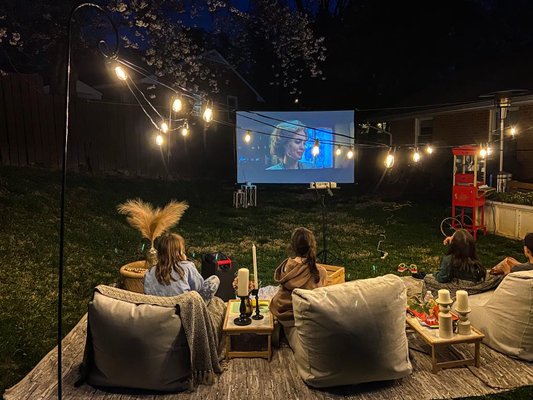 Outdoor Movie Night - Our Movie Night package comes styled with gorgeous accessories for a cozy night watching your favorite movies under the stars. Choose which movie to watch while we bring this deluxe movie night experience to your backyard. This package is the perfect way to create fun memories with your family and friends. Outdoor Movie Night - Our Movie Night package comes styled with gorgeous accessories for a cozy night watching your favorite movies under the stars. Choose which movie to watch while we bring this deluxe movie night experience to your backyard. This package is the perfect way to create fun memories with your family and friends.