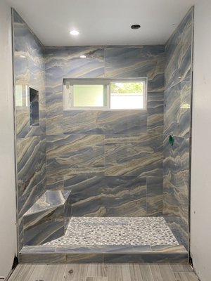 Shower Remodel 2023 - This is a remodel of an old shower. The customer wanted an upgrade to their bathroom by creating a more modern shower. We decided to cut out an old tub and provide an open space for a walk in shower. The tile was selected by the customer; however we matched the backsplash with the detailing of the tile that was selected. Shower Remodel 2023 - This is a remodel of an old shower. The customer wanted an upgrade to their bathroom by creating a more modern shower. We decided to cut out an old tub and provide an open space for a walk in shower. The tile was selected by the customer; however we matched the backsplash with the detailing of the tile that was selected.