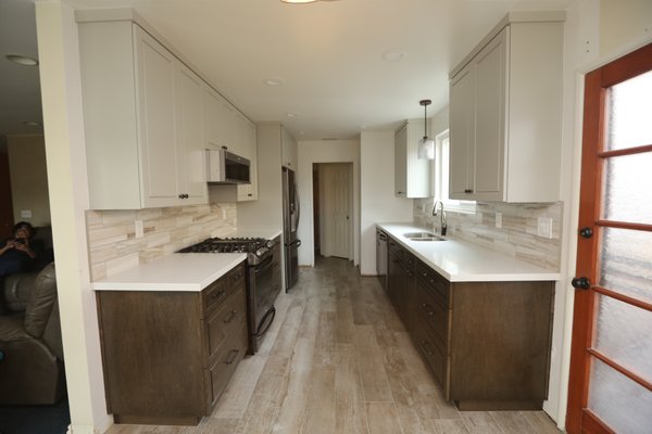 La Mirada Kitchen Remodel - Functional and Beautiful 2020 - As you can see the original cabinets and old tile counter tops had run their course. The homeowners had our team here at Cabinet Magic transform this outdated kitchen into a new, functional and beautiful workspace. Custom stained base cabinets with custom painted upper cabinets. Quartz counter tops with a porcelain tile back splash and tile flooring. The colors all pull together nicely for a warm and inviting upgrade to the home. La Mirada Kitchen Remodel - Functional and Beautiful 2020 - As you can see the original cabinets and old tile counter tops had run their course. The homeowners had our team here at Cabinet Magic transform this outdated kitchen into a new, functional and beautiful workspace. Custom stained base cabinets with custom painted upper cabinets. Quartz counter tops with a porcelain tile back splash and tile flooring. The colors all pull together nicely for a warm and inviting upgrade to the home.