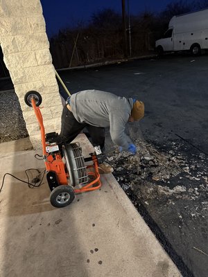 Augering a drain clog on the main line for a commercial customer. - This customer called us out to unclog the main line from the parking lot. It was unfortunately overflowing into their parking lot and causing a big mess. Augering a drain clog on the main line for a commercial customer. - This customer called us out to unclog the main line from the parking lot. It was unfortunately overflowing into their parking lot and causing a big mess.