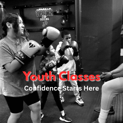 Youth Classes - Our youth boxing classes are designed to help kids and teens build confidence, discipline, and athletic ability in a positive, structured environment. Led by experienced coaches, each class introduces age-appropriate boxing fundamentals, conditioning, coordination drills, and teamwork—without pressure or intimidation.
Beyond fitness, youth athletes learn focus, respect, resilience, and how to challenge themselves in healthy ways. Classes are energetic and engaging, with an emphasis on effort, progress, and fun. Whether your child is brand new to sports or already active, they’ll feel supported while learning skills that translate far beyond the gym.
Sparring is not required—just movement, learning, and confidence building. Youth Classes - Our youth boxing classes are designed to help kids and teens build confidence, discipline, and athletic ability in a positive, structured environment. Led by experienced coaches, each class introduces age-appropriate boxing fundamentals, conditioning, coordination drills, and teamwork—without pressure or intimidation.
Beyond fitness, youth athletes learn focus, respect, resilience, and how to challenge themselves in healthy ways. Classes are energetic and engaging, with an emphasis on effort, progress, and fun. Whether your child is brand new to sports or already active, they’ll feel supported while learning skills that translate far beyond the gym.
Sparring is not required—just movement, learning, and confidence building.