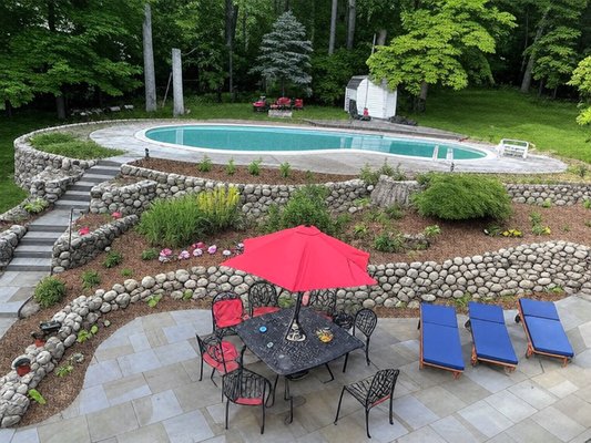 Patio, bed, and planting - We designed and built this patio and landscape to make our clients home feel like a backyard vacation.