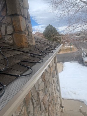 Snow/Ice Solutions & Heat Tape - Ice dams can form dangerous icicles and cause water seepage into homes and commercial buildings. Ice dams form as a result of melting snow and ice freezing on the roof when they reach the cold roof edge. The ice forms a barrier, and melted water accumulates behind this dam. Pooled water behind the dam is a serious issue because it may leak into the building, causing water damage, or it could run over the ice-filled gutter and form icicles.
The Mile High Gutter solution:
We use self-regulating heat tape to de-ice your roof and gutter system, which provides a continuous path for melted ice and snow to safely drain from the roof through the gutter and downspout.
Versatile, reliable, energy-saving and cost-effective, these systems are the most effective answer for roof and gutter de-icing applications. Snow/Ice Solutions & Heat Tape - Ice dams can form dangerous icicles and cause water seepage into homes and commercial buildings. Ice dams form as a result of melting snow and ice freezing on the roof when they reach the cold roof edge. The ice forms a barrier, and melted water accumulates behind this dam. Pooled water behind the dam is a serious issue because it may leak into the building, causing water damage, or it could run over the ice-filled gutter and form icicles.
The Mile High Gutter solution:
We use self-regulating heat tape to de-ice your roof and gutter system, which provides a continuous path for melted ice and snow to safely drain from the roof through the gutter and downspout.
Versatile, reliable, energy-saving and cost-effective, these systems are the most effective answer for roof and gutter de-icing applications.