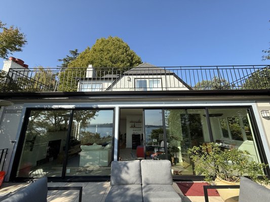 Lake Washington Moving Glass Walls, Windows & Doors - Our team recently completed a full transformation at this Lake Washington home. Previously, outdated grids and failed windows obstructed our customers' stunning views and limited access to their outdoor living space. To bring their vision to life, we reframed the opening, added structural headers, managed the entire permit process, and installed beautiful new Milgard Stacking Doors. Additionally, in the basement, we removed all of the failed windows with grids and installed new windows and fiberglass French doors so our customer can clearly see the beautiful views. Now, our customers can fully embrace the sun, fresh air, and seamless indoor-outdoor living! Lake Washington Moving Glass Walls, Windows & Doors - Our team recently completed a full transformation at this Lake Washington home. Previously, outdated grids and failed windows obstructed our customers' stunning views and limited access to their outdoor living space. To bring their vision to life, we reframed the opening, added structural headers, managed the entire permit process, and installed beautiful new Milgard Stacking Doors. Additionally, in the basement, we removed all of the failed windows with grids and installed new windows and fiberglass French doors so our customer can clearly see the beautiful views. Now, our customers can fully embrace the sun, fresh air, and seamless indoor-outdoor living!