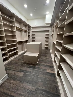 Modern Luxe Walk-In Closet Remodel - This custom walk-in closet combines modern elegance with everyday functionality. Designed with sleek built-ins, soft neutral tones, and rich wood-look flooring, it maximizes storage without sacrificing style. Floating shelves, spacious compartments, and a dedicated spot for a full-length mirror bring both beauty and practicality to this personalized space — a perfect balance of form and function. Modern Luxe Walk-In Closet Remodel - This custom walk-in closet combines modern elegance with everyday functionality. Designed with sleek built-ins, soft neutral tones, and rich wood-look flooring, it maximizes storage without sacrificing style. Floating shelves, spacious compartments, and a dedicated spot for a full-length mirror bring both beauty and practicality to this personalized space — a perfect balance of form and function.