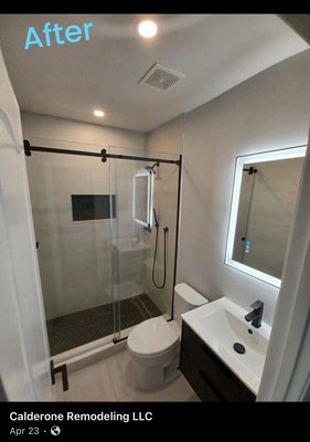 Bathroom Remodel - This bathroom remodel began with a stripped-down, unfinished space. Our team installed durable cement board before transforming the area with marble-look tiles, modern hexagon flooring, and elegant gold fixtures. Stylish accents and custom fixtures completed the upgrade, turning the bathroom into a contemporary and comfortable retreat.
