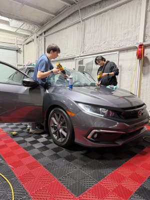 Clear Ceramic Windshield Tint - Windshield tinting is one of the most effective upgrades you can make for comfort and safety. Our advanced nano-ceramic windshield films are engineered for maximum heat rejection, making a huge difference in how your vehicle feels—especially in Georgia’s sun.
Our windshield tint blocks infrared heat, UV rays, and harmful glare while maintaining perfect visibility day and night. It helps reduce eye strain, keeps your cabin cooler, and protects your dashboard, screens, and interior materials from fading.
Whether you drive a truck, SUV, EV, or sports car, windshield tinting delivers:
* Significant heat reduction
* 99% UV protection
* Reduced glare for safer driving
* Less strain on your AC
* Enhanced comfort for long trips
* A cleaner, more modern look
We install using precision-cut patterns for a perfect fit with no distortion and no interference with sensors, cameras, or ADAS systems. Our ceramic films are designed for today’s vehicles with advanced technology built into the glass.
Windshield tint is the ideal upgrade for daily drivers, commuters, families, and anyone who wants a cooler, more comfortable ride. Most customers say this is the single biggest improvement they feel after tinting their vehicle.
Fast installation, premium materials, and long-lasting clarity—experience the difference of professional windshield tinting at Turbo Tint Marietta. Clear Ceramic Windshield Tint - Windshield tinting is one of the most effective upgrades you can make for comfort and safety. Our advanced nano-ceramic windshield films are engineered for maximum heat rejection, making a huge difference in how your vehicle feels—especially in Georgia’s sun.
Our windshield tint blocks infrared heat, UV rays, and harmful glare while maintaining perfect visibility day and night. It helps reduce eye strain, keeps your cabin cooler, and protects your dashboard, screens, and interior materials from fading.
Whether you drive a truck, SUV, EV, or sports car, windshield tinting delivers:
* Significant heat reduction
* 99% UV protection
* Reduced glare for safer driving
* Less strain on your AC
* Enhanced comfort for long trips
* A cleaner, more modern look
We install using precision-cut patterns for a perfect fit with no distortion and no interference with sensors, cameras, or ADAS systems. Our ceramic films are designed for today’s vehicles with advanced technology built into the glass.
Windshield tint is the ideal upgrade for daily drivers, commuters, families, and anyone who wants a cooler, more comfortable ride. Most customers say this is the single biggest improvement they feel after tinting their vehicle.
Fast installation, premium materials, and long-lasting clarity—experience the difference of professional windshield tinting at Turbo Tint Marietta.