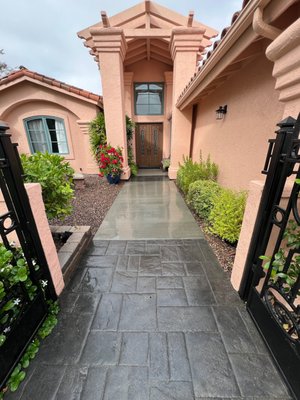 Walkway Remodel - This expertly remodeled concrete walkway, created a sleek and modern path that enhances the entrance to this beautiful home. The project features smooth concrete sections, providing both aesthetic appeal and functionality. The seamless integration with the surrounding landscaping and the clean, precise finish exemplify the high-quality craftsmanship and attention to detail that San Diego Concrete Services is known for. This elegant walkway not only boosts curb appeal but also ensures durability and easy maintenance for years to come. Contact us to transform your outdoor spaces with our professional concrete solutions.