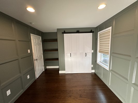 Sophisticated Office Makeover with Box Molding and Modern Touches - For this office transformation, we aimed to create an upscale, sophisticated look while keeping the space functional and inviting. The process began with flat walls, which we upgraded by installing wood box molding on two walls, creating elegant accent walls that added depth, instantly elevating the room's aesthetic. We painted the walls in Sherwin Williams "Retreat" SW6207 (Interior Duration Satin) to unify the space with a timeless, calming green-gray hue.
To maximize storage and style, we installed custom floating shelves in a nook, providing a sleek, modern solution for organizing and displaying items. The existing double closet doors were replaced with a sliding barn door, which glides effortlessly on a track, offering a contemporary and space-saving alternative.
This project highlights how targeted updates, like accent paneling and functional design elements, can transform an office into a polished and inviting space. Sophisticated Office Makeover with Box Molding and Modern Touches - For this office transformation, we aimed to create an upscale, sophisticated look while keeping the space functional and inviting. The process began with flat walls, which we upgraded by installing wood box molding on two walls, creating elegant accent walls that added depth, instantly elevating the room's aesthetic. We painted the walls in Sherwin Williams "Retreat" SW6207 (Interior Duration Satin) to unify the space with a timeless, calming green-gray hue.
To maximize storage and style, we installed custom floating shelves in a nook, providing a sleek, modern solution for organizing and displaying items. The existing double closet doors were replaced with a sliding barn door, which glides effortlessly on a track, offering a contemporary and space-saving alternative.
This project highlights how targeted updates, like accent paneling and functional design elements, can transform an office into a polished and inviting space.