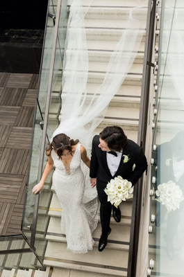 TIMELESS WEDDING AT THE LONDON HOTEL IN WEST HOLLYWOOD, CALIFORNIA WEDDING IN WEST HOLLYWOOD, CALIFORNIA - XO Bloom utilized bright white florals and lush greenery to further elevate the timeless elegance of this wedding. The translucent chuppah elevated white roses and hydrangeas above the couple as they exchanged vows. A similar design was featured at the reception with cascading white florals above each tablescape. The incredible florals did not stop with the décor, we loved the wedding cake with roses at each tier.