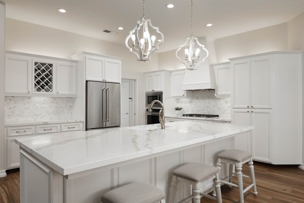 Kitchen Remodel 2022 - This kitchen needed a full update. New kitchen island, cabinets, countertops, lighting and mosaic backsplash. The beautiful quartz countertops, marble mosaic backsplash and champagne gold hardware makes this kitchen a timeless beauty.