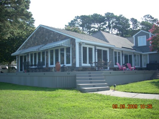 Beautiful waterfront view - New windows, vinyl siding, stone, and trim looking great! Beautiful looking from the street and from the water. Beautiful waterfront view - New windows, vinyl siding, stone, and trim looking great! Beautiful looking from the street and from the water.