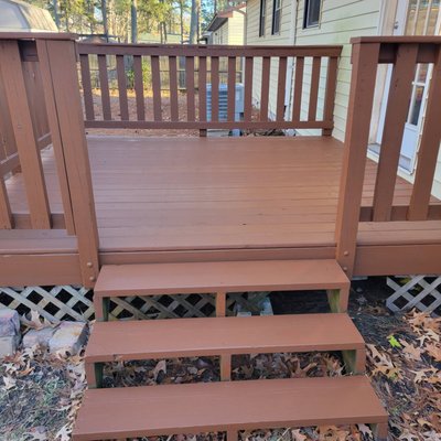 Deck Repair & Staining - The surface of this deck had become severely rotten. We replaced all of the rotten wood with 20-year pressure-treated pine, then stained the deck to extend its life and add visual appeal.