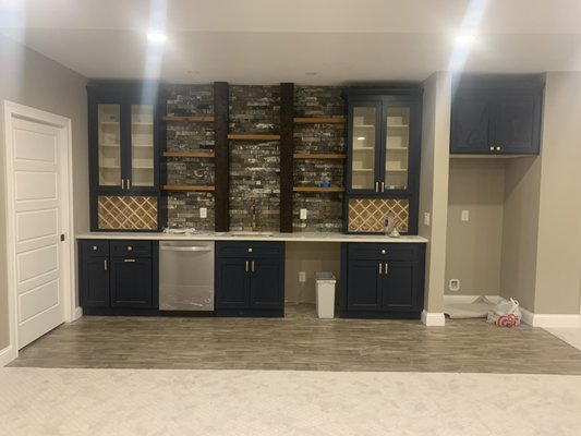 Basement Remodel - This home had an unfinished section of the basement and wanted to fill the space with a “wet bar”. We went in and completed their wanted look in 7 days to include carpet, sink, dishwasher, lighted wine cabinets and shelving. Along with the cabinets we installed a quartz countertop. Basement Remodel - This home had an unfinished section of the basement and wanted to fill the space with a “wet bar”. We went in and completed their wanted look in 7 days to include carpet, sink, dishwasher, lighted wine cabinets and shelving. Along with the cabinets we installed a quartz countertop.