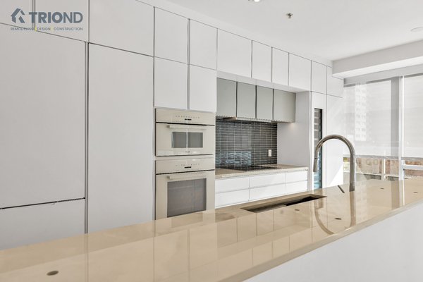 Living room and kitchen remodeling. - This stunning transformation breathes new life into an outdated kitchen! The clean white finishes bring a sense of brightness and sophistication, while the black tiles add a bold, modern contrast. Paired with an inviting living room and enhanced by incredible natural lighting, this remodel creates a seamless flow that’s perfect for cooking, relaxing, and entertaining.
