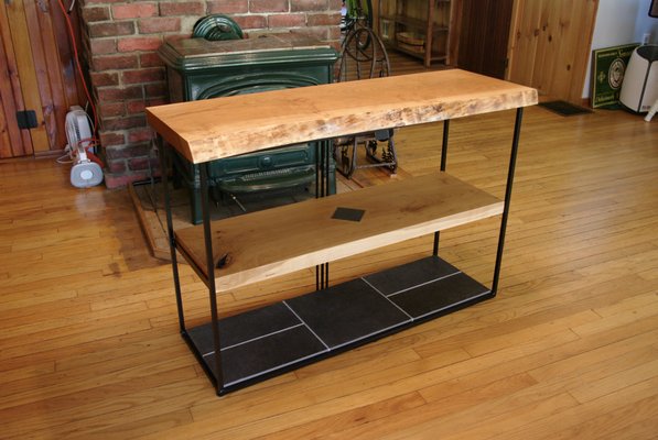 Custom Fabricated This Live Edge Cherry and Stone Inlay Accent Table/Shelf - This Live Edge Cherry and Stone Inlay Accent Table/Shelf was created as a custom piece for a client seeking to enhance their living room decor. The client approached MK with specific design preferences, requesting a table made of cherry wood with a live edge and metal shelves. MK collaborated closely with the client to develop several design concepts that aligned with their vision. The final design featured a striking three-shelf structure, showcasing a live-edge cherry wood top, a cherry stone inlay accent on the center shelf, and a fully stone-inlaid bottom shelf. The result is a beautifully crafted table that not only meets the client's specifications but also adds an elegant touch to their living space. Custom Fabricated This Live Edge Cherry and Stone Inlay Accent Table/Shelf - This Live Edge Cherry and Stone Inlay Accent Table/Shelf was created as a custom piece for a client seeking to enhance their living room decor. The client approached MK with specific design preferences, requesting a table made of cherry wood with a live edge and metal shelves. MK collaborated closely with the client to develop several design concepts that aligned with their vision. The final design featured a striking three-shelf structure, showcasing a live-edge cherry wood top, a cherry stone inlay accent on the center shelf, and a fully stone-inlaid bottom shelf. The result is a beautifully crafted table that not only meets the client's specifications but also adds an elegant touch to their living space.