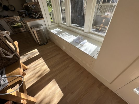 Bench installation under the window for our client. - We designed and installed a bench with storage space under the window for our client in Pasadena. Now they can spend warm evenings enjoying the view from their large window.