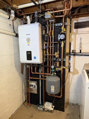 Navien NCB boiler install - This project included removing a non operational condensing wall hung boiler, building a wall in front of the existing building drain and installing a Navien NCB condensing wall hung Combi boiler. Book service today and ask us how we can help cut your gas bills in half!