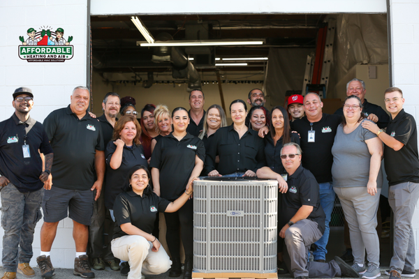 Affordable HVAC Team - A vibrant team photo showcasing the dedicated professionals at Affordable Heating and Air, a leading Los Angeles HVAC contractor. This image captures the spirit of our company, highlighting the diverse team that makes us a trusted choice for AC repair, furnace installation, and HVAC maintenance in the LA area.
In the center of the photo, a modern HVAC condenser unit symbolizes our expertise in air conditioning services. Surrounding the condenser, our team members, a diverse group of men and women, pose confidently. They wear matching black polo shirts emblazoned with the Affordable Heating and Air logo, reinforcing our brand identity and professional approach to heating and cooling solutions.
The backdrop features our company’s location, with a roll-up door and a ladder visible, suggesting a busy, hands-on environment where we tackle HVAC installation and HVAC repair with efficiency and expertise. The bright, outdoor setting reflects our commitment to serving the Los Angeles community with reliable and affordable HVAC services.
This image represents our commitment to quality work, customer satisfaction, and our position as a go-to HVAC company for all Los Angeles heating and air conditioning needs. Choose Affordable Heating and Air for your next HVAC project and experience the difference. Affordable HVAC Team - A vibrant team photo showcasing the dedicated professionals at Affordable Heating and Air, a leading Los Angeles HVAC contractor. This image captures the spirit of our company, highlighting the diverse team that makes us a trusted choice for AC repair, furnace installation, and HVAC maintenance in the LA area.
In the center of the photo, a modern HVAC condenser unit symbolizes our expertise in air conditioning services. Surrounding the condenser, our team members, a diverse group of men and women, pose confidently. They wear matching black polo shirts emblazoned with the Affordable Heating and Air logo, reinforcing our brand identity and professional approach to heating and cooling solutions.
The backdrop features our company’s location, with a roll-up door and a ladder visible, suggesting a busy, hands-on environment where we tackle HVAC installation and HVAC repair with efficiency and expertise. The bright, outdoor setting reflects our commitment to serving the Los Angeles community with reliable and affordable HVAC services.
This image represents our commitment to quality work, customer satisfaction, and our position as a go-to HVAC company for all Los Angeles heating and air conditioning needs. Choose Affordable Heating and Air for your next HVAC project and experience the difference.