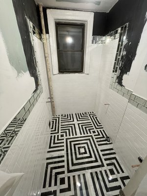 Tiling - This small bathroom has been tiled up with 32x32 tiles and the pattern has been followed and matched with each one. White subway tiles for walls along with 2 lines of glass tiles, which have been professionally cut and sanded to get rid of any chips. Call us for a professional tile job done right! Tiling - This small bathroom has been tiled up with 32x32 tiles and the pattern has been followed and matched with each one. White subway tiles for walls along with 2 lines of glass tiles, which have been professionally cut and sanded to get rid of any chips. Call us for a professional tile job done right!