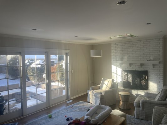 Living room recessed can installation 9x - This is a upgrade to a older wilmette home for a new family with young kids where lighting is important as well as good power. We installed 8 can lights as general light on one switch and a directional led over the fireplace on another switch. Both switches are 3-way switches to improve flow and accessibility of the house