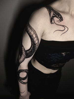 Snake full arm piece - This piece was custom made for the client, she requested something bold but yet delicate look to fit the space of the arm including partial back and partial front, our resident artist made this possible with much attention to detail and overall tattoo process to  assure best results and outcome for the piece and for the client.