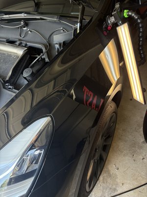 2022 Tesla Model Y, front fender repair - This 2022 Tesla Model Y had a small fender dent from a baseball bat dropping on it in their garage. The dent was fairly easy to access, and the repairs only took 1 and a half hours to complete. The customer was completely satisfied and said that we were their “go to” dent company now.