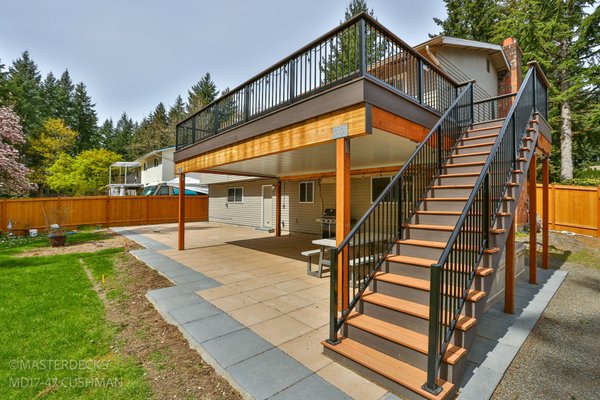 RC2021 - Perched high above, this second-level deck is the epitome of understated luxury. Dressed in composite decking, its surface combines practicality with opulence, creating a foundation that's as refined as it is resilient.
The deck is encircled by a picket railing, a timeless choice that adds a touch of sophistication while maintaining an open, airy feel. The simple yet elegant design of the picket railing frames the elevated space, offering safety without compromising the deck's panoramic views.
As you ascend the stairs, the continuity of style unfolds with matching picket railings, a seamless extension of the deck's aesthetic. Each step becomes a transition, marrying functionality with the charm of a well-designed outdoor space. RC2021 - Perched high above, this second-level deck is the epitome of understated luxury. Dressed in composite decking, its surface combines practicality with opulence, creating a foundation that's as refined as it is resilient.
The deck is encircled by a picket railing, a timeless choice that adds a touch of sophistication while maintaining an open, airy feel. The simple yet elegant design of the picket railing frames the elevated space, offering safety without compromising the deck's panoramic views.
As you ascend the stairs, the continuity of style unfolds with matching picket railings, a seamless extension of the deck's aesthetic. Each step becomes a transition, marrying functionality with the charm of a well-designed outdoor space.
