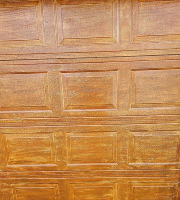 Garage door improvement - This garage door was about to be replaced.  I created a fresh look and added curb appeal with a staining technique.