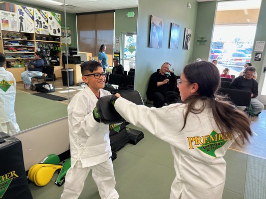 Kids Martial Arts Confidence-Building Intro Class - At Premier Martial Arts Arapahoe, our kids martial arts classes are designed to help students build confidence, focus, self-discipline, respect, and practical self-defense skills in a fun and supportive environment.
This introductory class experience helps new students learn basic martial arts movements, practice listening and self-control, meet our instructors, and experience the positive energy of our school. Families get to see how martial arts can support growth both on and off the mat.
Our goal is for every student to leave feeling proud, encouraged, and excited to keep growing. Kids Martial Arts Confidence-Building Intro Class - At Premier Martial Arts Arapahoe, our kids martial arts classes are designed to help students build confidence, focus, self-discipline, respect, and practical self-defense skills in a fun and supportive environment.
This introductory class experience helps new students learn basic martial arts movements, practice listening and self-control, meet our instructors, and experience the positive energy of our school. Families get to see how martial arts can support growth both on and off the mat.
Our goal is for every student to leave feeling proud, encouraged, and excited to keep growing.