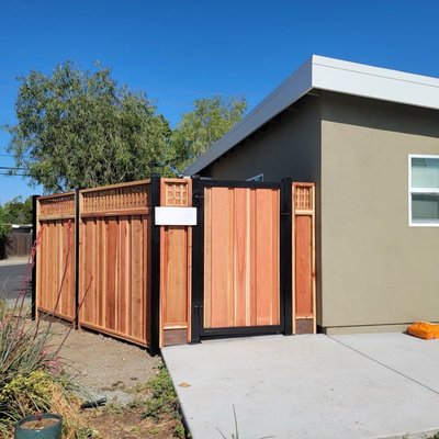 Board on Board, Redwood Fence with Metal Posts and Square Lattice - Our client requested to have his fence built with metal posts. Although the cost was higher than a fence with pressure treated Douglas fir posts, in the long run the metal posts will save him money. Board on Board, Redwood Fence with Metal Posts and Square Lattice - Our client requested to have his fence built with metal posts. Although the cost was higher than a fence with pressure treated Douglas fir posts, in the long run the metal posts will save him money.