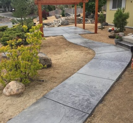 Walkway Projects - At Complete Concrete, we believe your walkway should be as strong as it is beautiful. Our walkway installation process begins with a personalized consultation to understand your vision and how the space will be used. We evaluate the area for proper grading, drainage, and functionality to ensure your walkway is safe, smooth, and long-lasting. Once the design is finalized, we prepare the site by clearing and leveling the ground before installing a compacted base to prevent shifting and settling. We then pour or lay the chosen concrete or pavers with precision, taking care to create clean lines and a finish that complements your home or landscape. To enhance durability and appearance, we apply a professional-grade sealer that protects against moisture, stains, and weathering. For decorative or stamped walkways, we recommend resealing annually to preserve color richness and texture. Whether you're looking for a modern, classic, or custom finish, our team ensures quality workmanship and clear communication from start to finish—so every step feels just right. Walkway Projects - At Complete Concrete, we believe your walkway should be as strong as it is beautiful. Our walkway installation process begins with a personalized consultation to understand your vision and how the space will be used. We evaluate the area for proper grading, drainage, and functionality to ensure your walkway is safe, smooth, and long-lasting. Once the design is finalized, we prepare the site by clearing and leveling the ground before installing a compacted base to prevent shifting and settling. We then pour or lay the chosen concrete or pavers with precision, taking care to create clean lines and a finish that complements your home or landscape. To enhance durability and appearance, we apply a professional-grade sealer that protects against moisture, stains, and weathering. For decorative or stamped walkways, we recommend resealing annually to preserve color richness and texture. Whether you're looking for a modern, classic, or custom finish, our team ensures quality workmanship and clear communication from start to finish—so every step feels just right.