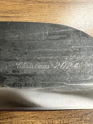 Custom Rotary Engraving on a Nikos Knife for a Family Christmas Gift - This project allowed us to help a customer create a truly special Christmas gift for their family. They selected a Nikos knife and entrusted us to personalize it with an engraved message, adding a unique and heartfelt touch to their holiday celebration.

We worked closely with the customer to select the ideal font and layout, ensuring the engraving would complement the knife’s design and capture the sentiment behind the gift. With the deadline approaching quickly, our team prioritized precision and efficiency, taking on the challenge of completing this custom job just in time for Christmas.

Using expert rotary engraving techniques, we carefully inscribed the chosen design on both sides of the knife, achieving a polished and durable result that the customer was thrilled to present to their family.

It was an honor to contribute to the joy and connection of their holiday season. This project highlights our commitment to quality craftsmanship, attention to detail, and helping customers bring their meaningful gift ideas to life, even under tight deadlines.