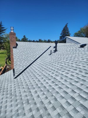 Silver + Black Accent Roof - This roof replacement features a sleek silver roof paired with bold black metal accessories, including vents, flashings, and trim. The high-contrast design delivers a modern, eye-catching aesthetic while maintaining durability and weather resistance. A perfect blend of form and function, this upgrade brings both style and long-term performance to the home. Silver + Black Accent Roof - This roof replacement features a sleek silver roof paired with bold black metal accessories, including vents, flashings, and trim. The high-contrast design delivers a modern, eye-catching aesthetic while maintaining durability and weather resistance. A perfect blend of form and function, this upgrade brings both style and long-term performance to the home.