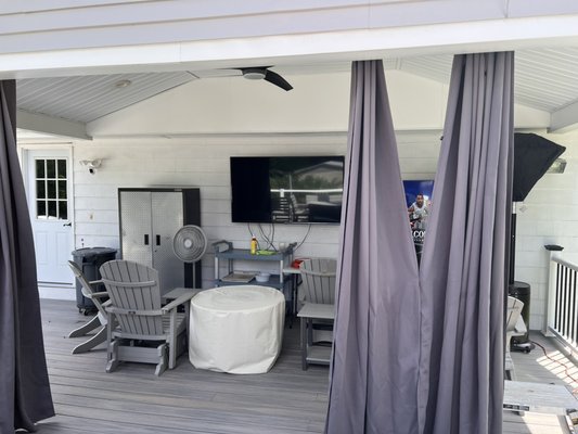 Exterior motorized solar shade project - This project was based on the clients need to improve privacy and block glare on an outdoor television. The deck area had interior draperies rigged up as a temporary fix. When I met with the client we discussed his needs and I recommended an electric motorized exterior solar shade. The clients were extremely happy with the price and the finished product. Exterior motorized solar shade project - This project was based on the clients need to improve privacy and block glare on an outdoor television. The deck area had interior draperies rigged up as a temporary fix. When I met with the client we discussed his needs and I recommended an electric motorized exterior solar shade. The clients were extremely happy with the price and the finished product.