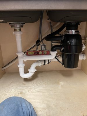 Garbage disposal - Installed garbage disposal, and drain assembly supporting double dish kitchen sink Garbage disposal - Installed garbage disposal, and drain assembly supporting double dish kitchen sink